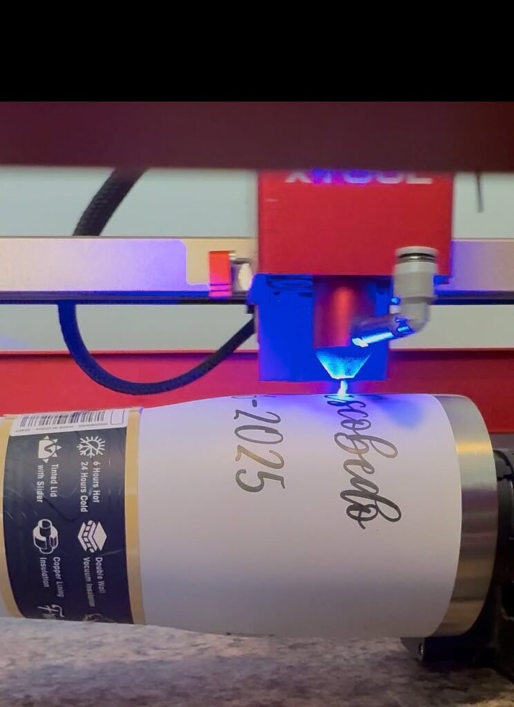 Laser engraving a custom name and date on a stainless steel tumbler