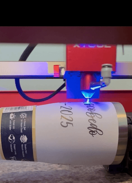 Laser engraving a custom stainless steel tumbler on a rotary attachment