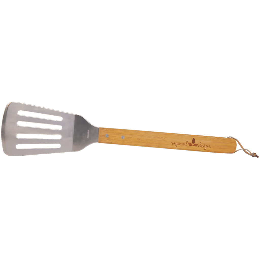 Stainless steel barbecue spatula with bamboo handle and engraved logo on a transparent background