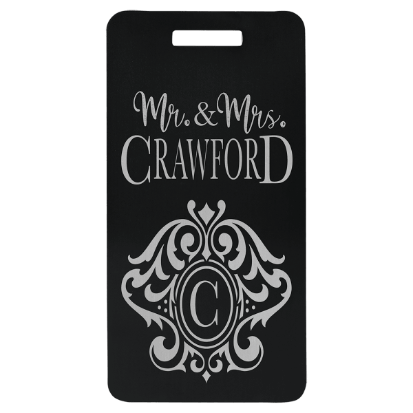 Black anodized aluminum luggage tag engraved with “Mr. & Mrs. Crawford” and decorative monogram.