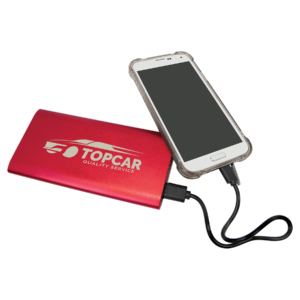 Red aluminum wireless charger power bank connected to a smartphone, featuring custom white laser engraved logo and 8000mAh rechargeable battery.