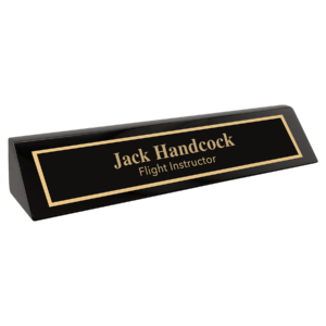 Personalized black desk wedge with a glossy piano finish and custom gold nameplate
